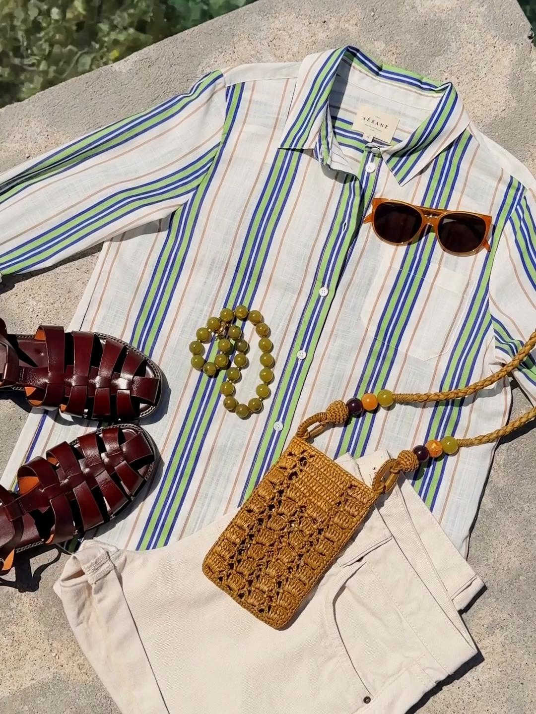 GET THE LOOK: Tomboy Shirt, Niels Shorts, Florie Sandals, Tasha Pouch, Romie Sunglasses, Danae Necklace 🔆 Wherever you’re headed next, make stripes and bold acc essories your new summer signature #sezane #summerfashion #summer #outfitideas #fashionstyle